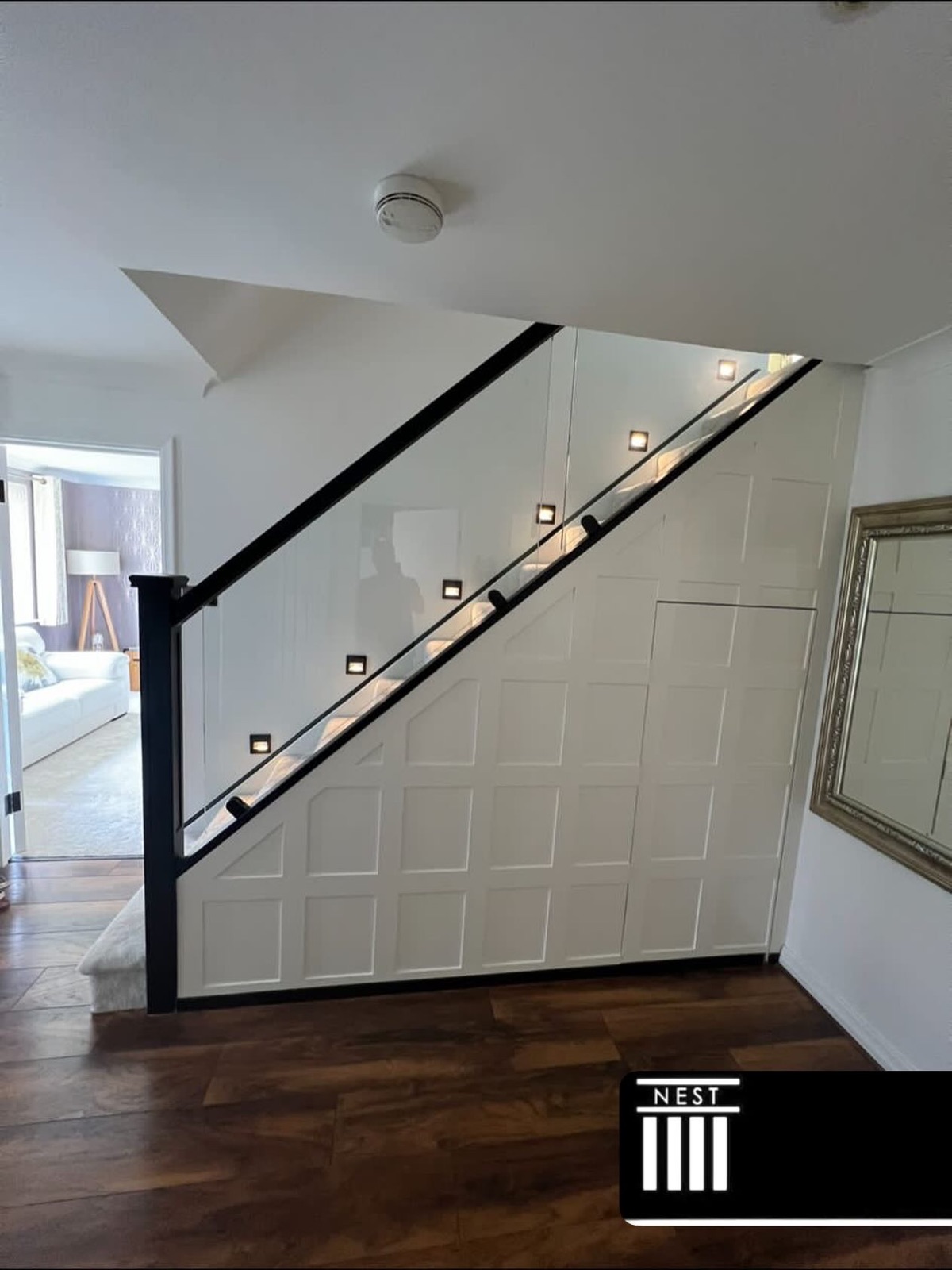 Bespoke staircase with glass panelling and feature lighting